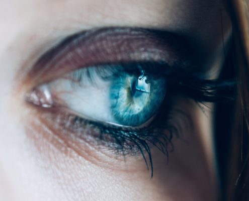 close up of a woman's blue eye