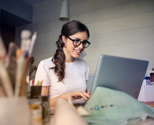 motivated woman in glasses sitting to do work