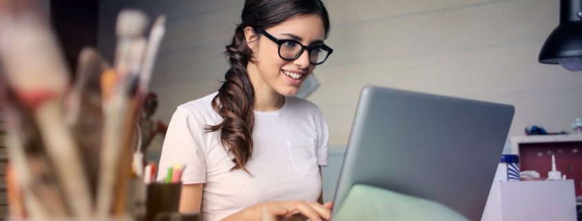 motivated woman in glasses sitting to do work