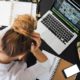 a woman struggling to do work on a laptop