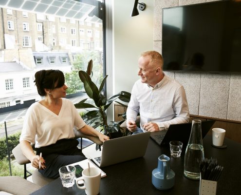 a man and a woman having conversation in the office